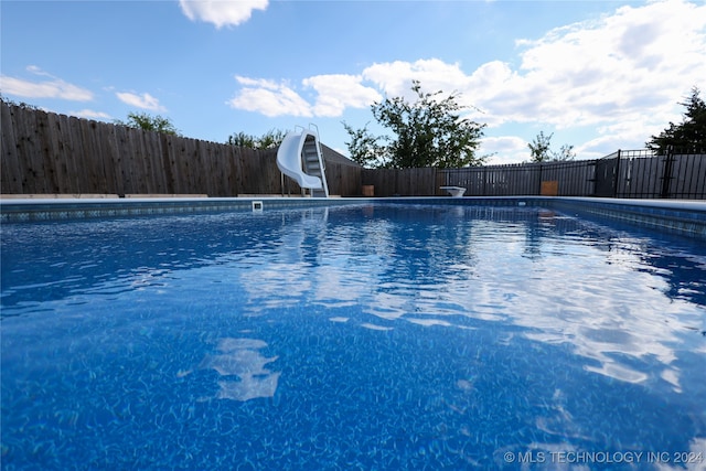 view of pool with a water slide