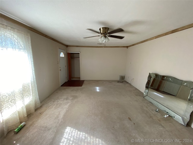 empty room with ceiling fan and crown molding