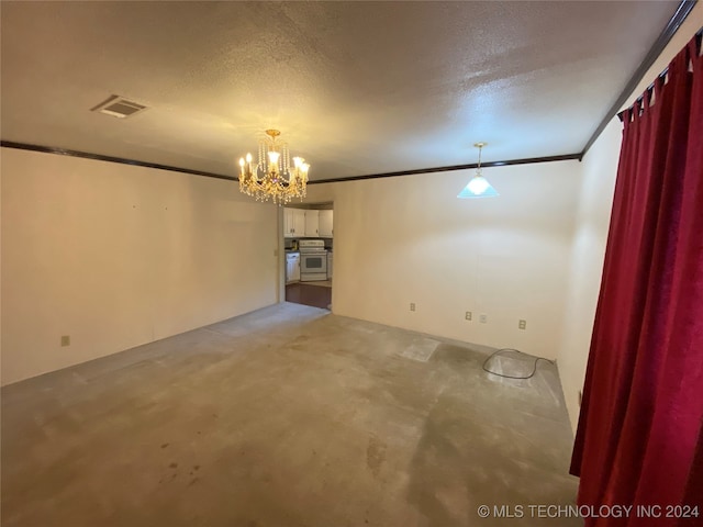 empty room featuring a textured ceiling, carpet, ornamental molding, and an inviting chandelier