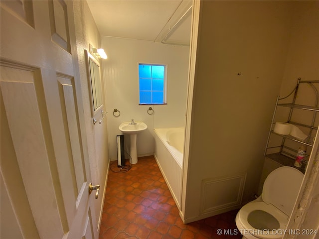 bathroom with sink, a bathtub, and toilet