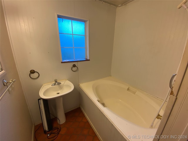 bathroom featuring tile patterned flooring and a tub