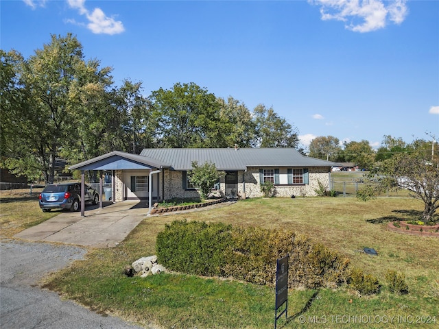 ranch-style home with a front yard and a carport