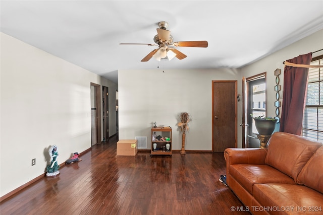 living room featuring dark hardwood / wood-style floors and ceiling fan