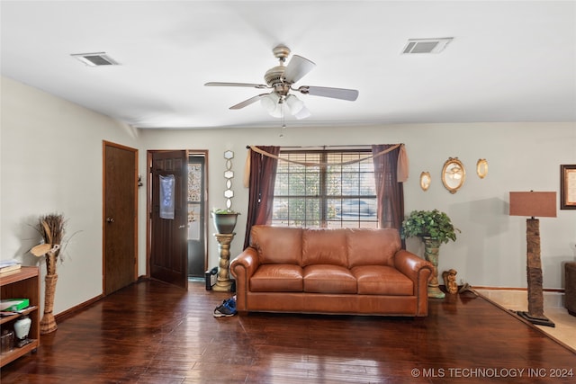 living room featuring dark wood-type flooring and ceiling fan