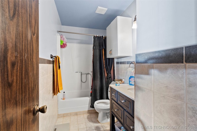 1421 S Hayes Ave, Wagoner, OK 74467 - full bathroom featuring tile walls, toilet, shower / tub combo with curtain, vanity, and tile patterned floors