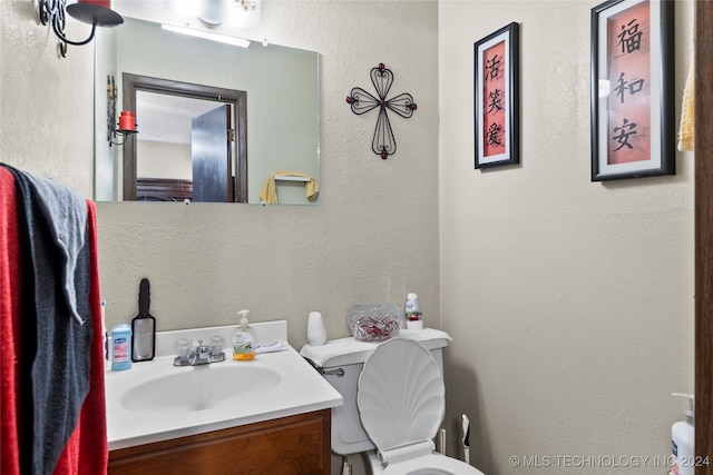 bathroom with toilet and vanity