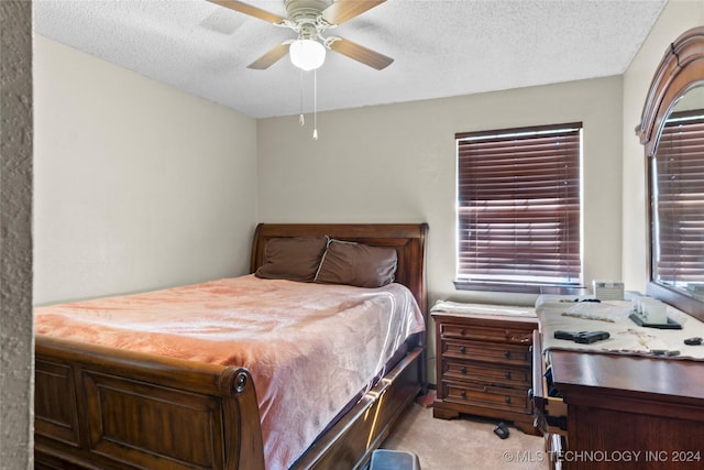 1421 S Hayes Ave, Wagoner, OK 74467 - bedroom with a textured ceiling, light carpet, a ceiling fan, and an office area