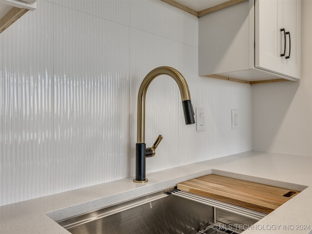 details with white cabinets and sink