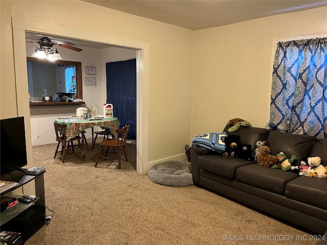 living room featuring ceiling fan and carpet