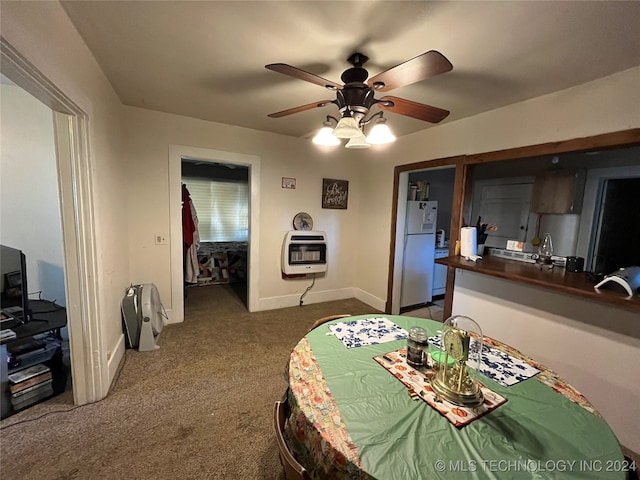 carpeted bedroom featuring heating unit, ceiling fan, a closet, and white refrigerator