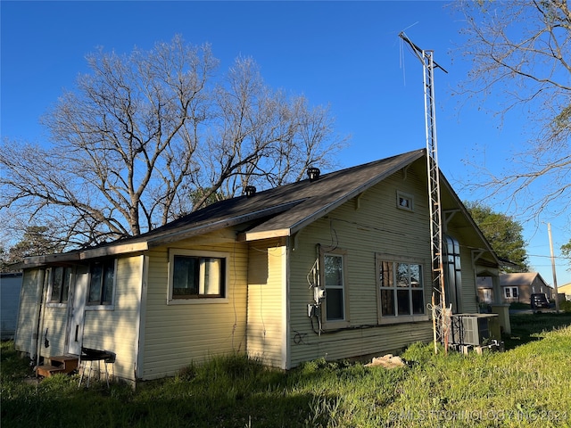 view of side of property with central air condition unit