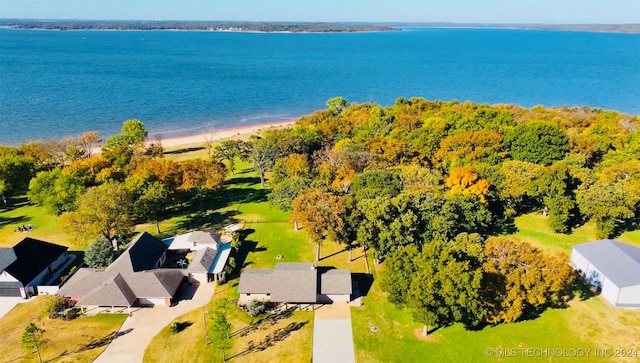 birds eye view of property featuring a water view and a beach view