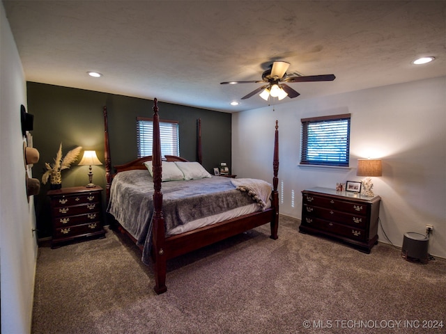 carpeted bedroom featuring a textured ceiling and ceiling fan