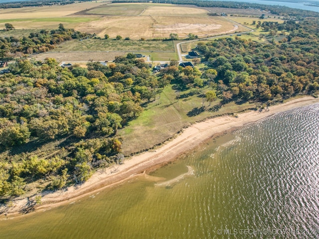 birds eye view of property featuring a water view and a rural view