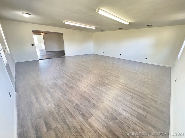 unfurnished room featuring ceiling fan and hardwood / wood-style floors