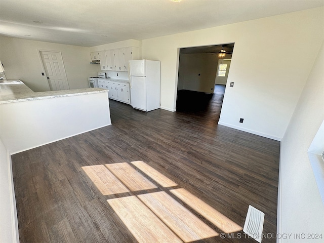 kitchen with ceiling fan, white cabinets, sink, white appliances, and dark wood-type flooring