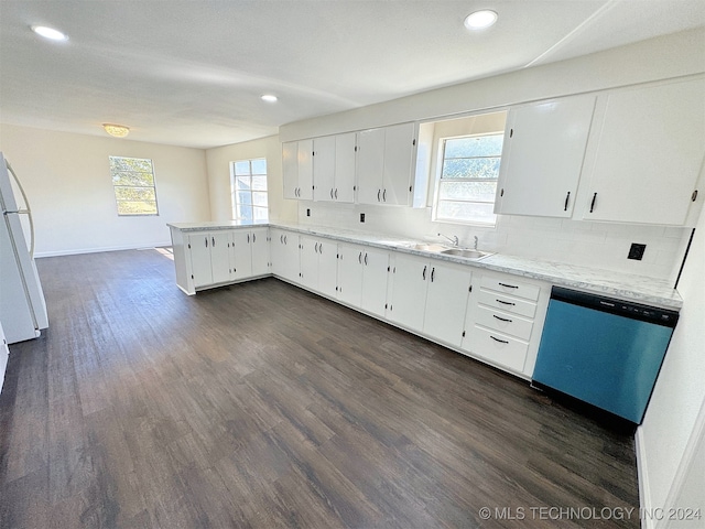 kitchen with white refrigerator, dark wood-type flooring, white cabinets, a healthy amount of sunlight, and stainless steel dishwasher