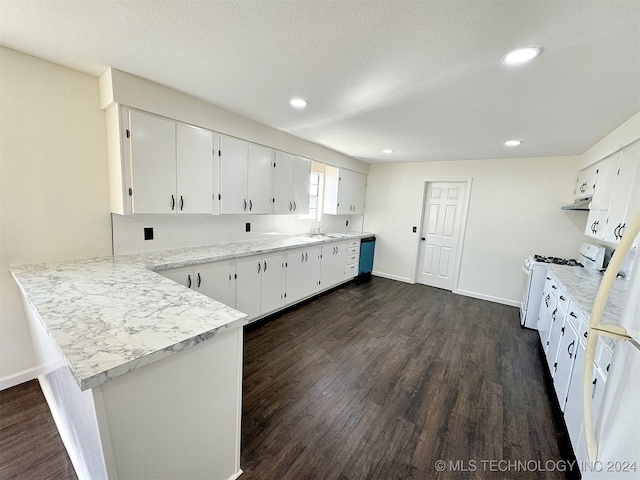 kitchen with white range oven, kitchen peninsula, white cabinetry, and dark hardwood / wood-style floors