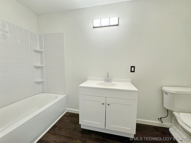 full bathroom with hardwood / wood-style floors, vanity, toilet, and  shower combination