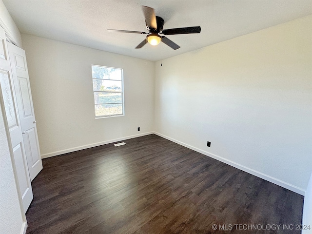 unfurnished bedroom with dark hardwood / wood-style floors and ceiling fan