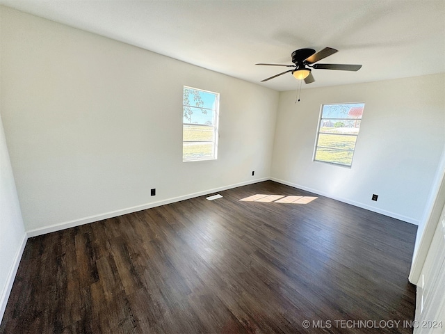 unfurnished room with ceiling fan and dark hardwood / wood-style floors