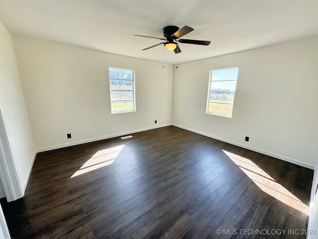 spare room featuring ceiling fan and dark wood-type flooring