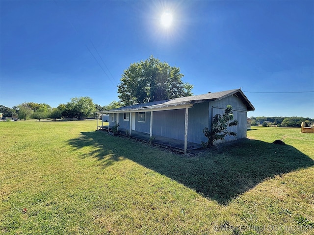 view of side of home with a lawn