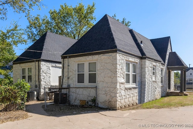 view of side of property featuring central AC