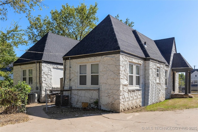 view of side of home featuring stone siding