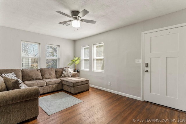 living area featuring dark wood-style floors, visible vents, baseboards, ceiling fan, and a textured ceiling