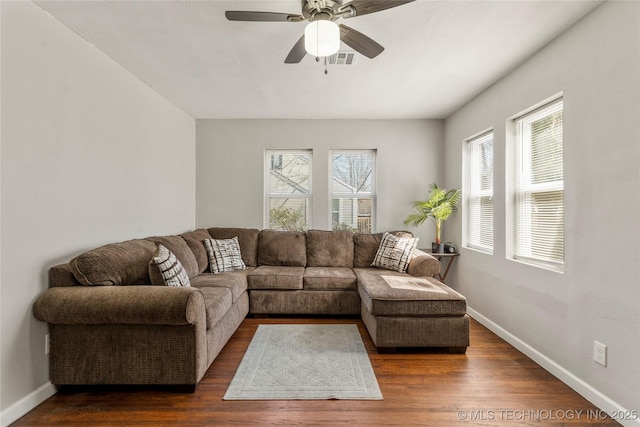 living room featuring ceiling fan, wood finished floors, visible vents, and baseboards