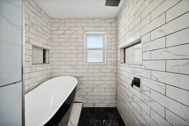 bathroom with separate shower and tub and tile walls