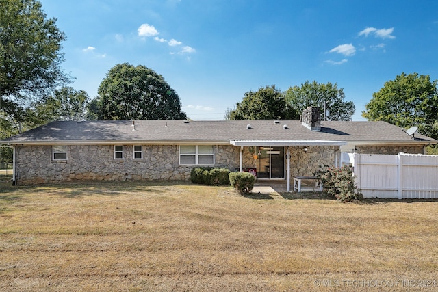 rear view of property with a yard and a patio area