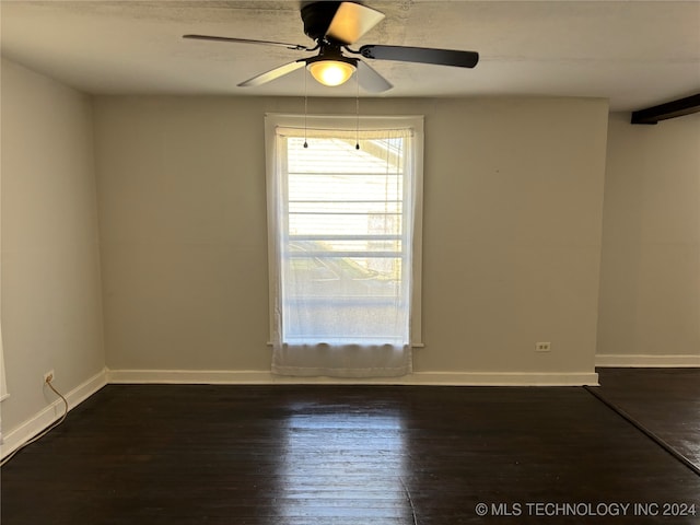 spare room featuring ceiling fan and dark wood-type flooring