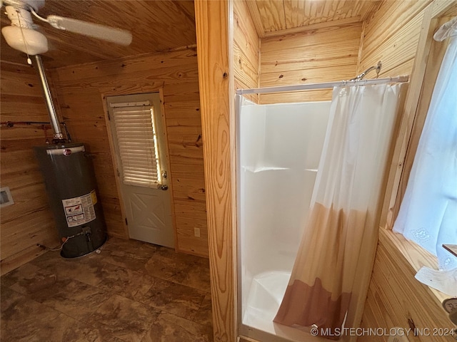 bathroom with ceiling fan, a shower with curtain, gas water heater, and wood walls