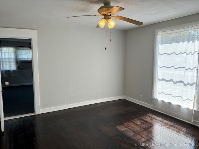 spare room featuring ceiling fan and dark hardwood / wood-style floors