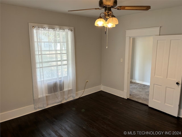 spare room featuring ceiling fan and dark hardwood / wood-style floors