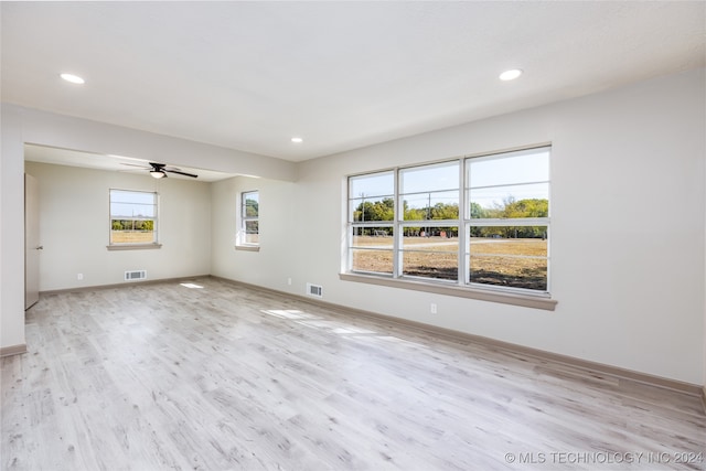 unfurnished room featuring ceiling fan, plenty of natural light, and light hardwood / wood-style floors