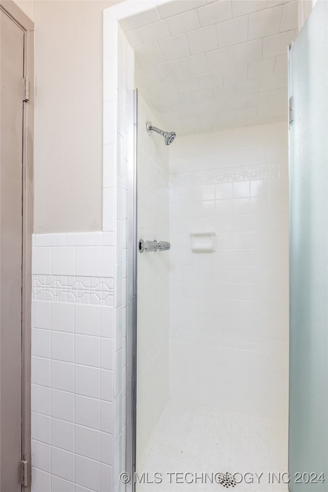 bathroom with a shower with shower door