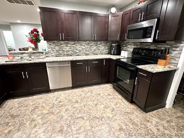 kitchen with decorative backsplash, dark brown cabinetry, sink, and stainless steel appliances