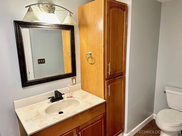 bathroom with vanity, toilet, and tile patterned floors