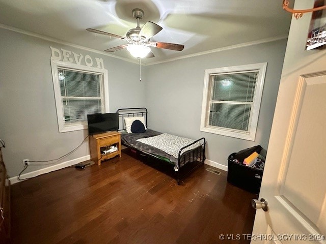 bedroom featuring ceiling fan, crown molding, and dark hardwood / wood-style flooring