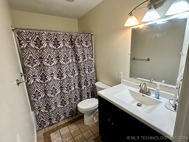 bathroom featuring curtained shower, vanity, toilet, and tile patterned floors