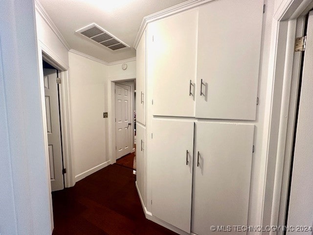 hallway featuring dark wood-type flooring and crown molding