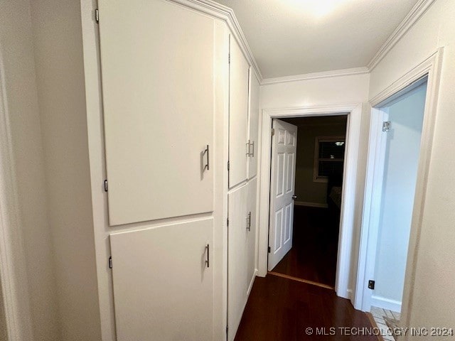 hall featuring crown molding and dark hardwood / wood-style flooring