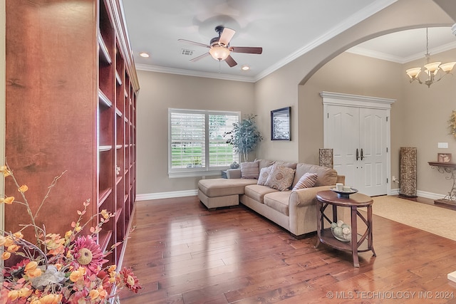 living room with ceiling fan with notable chandelier, crown molding, and dark wood-type flooring