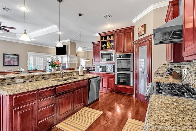 kitchen featuring pendant lighting, appliances with stainless steel finishes, tasteful backsplash, and dark hardwood / wood-style flooring