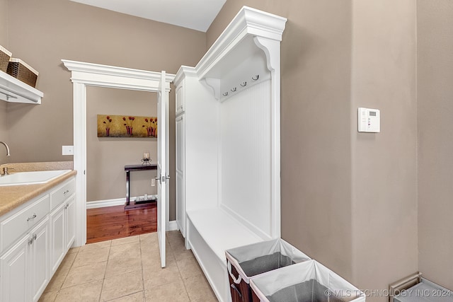 mudroom with light tile patterned floors and sink