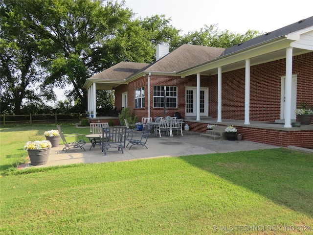 exterior space with a patio and a lawn