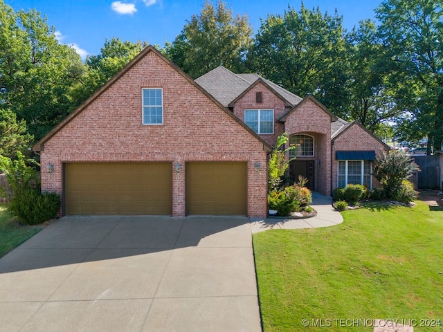 front facade featuring a front yard and a garage